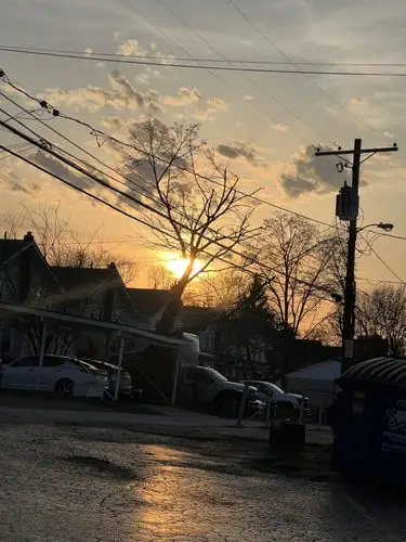 Warm light kisses the street as day ends.
